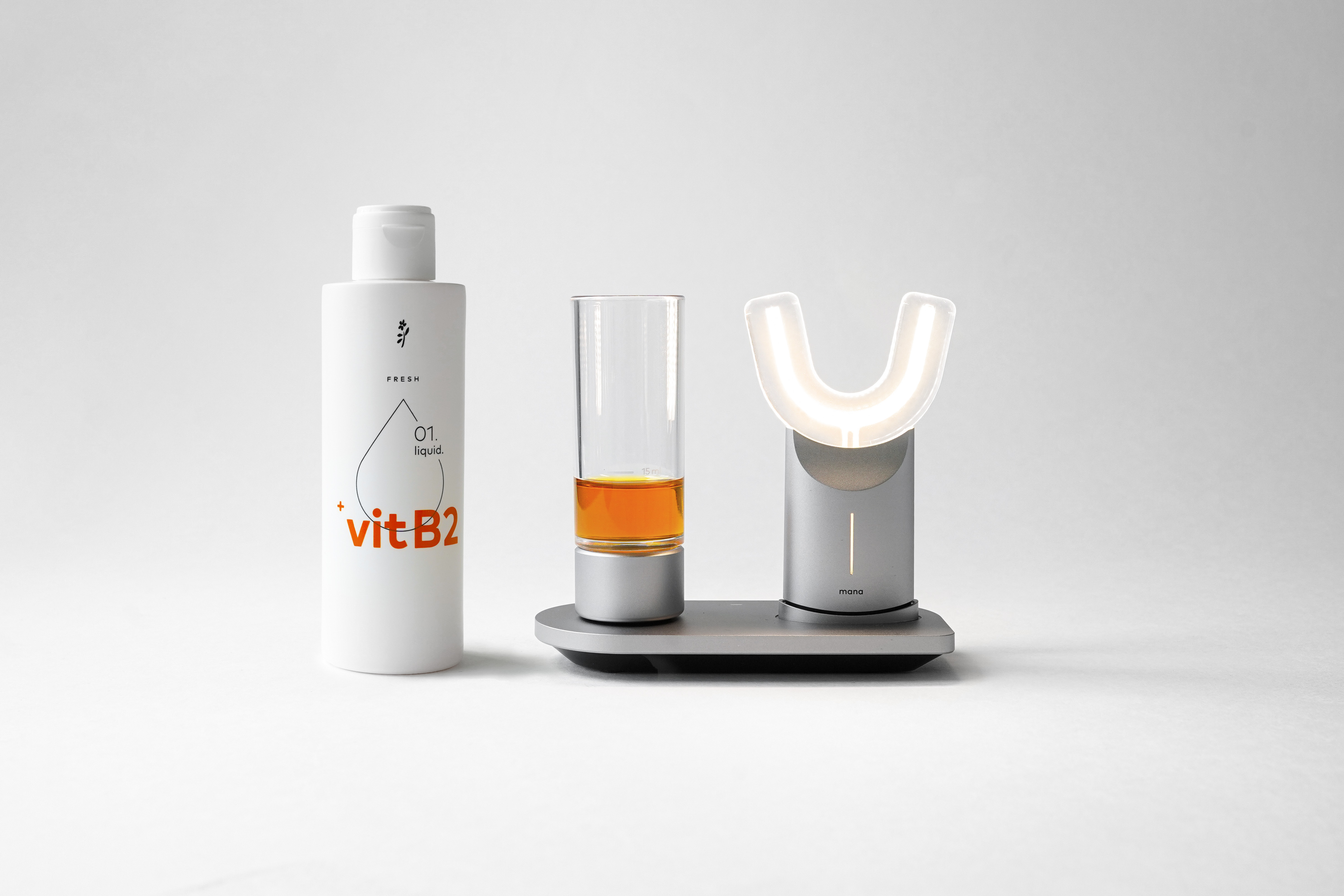 Eine Flasche des manadental Liquids und das manadental Produktsystem vor weißem Hintergrund - Abbildung für den Online Shop